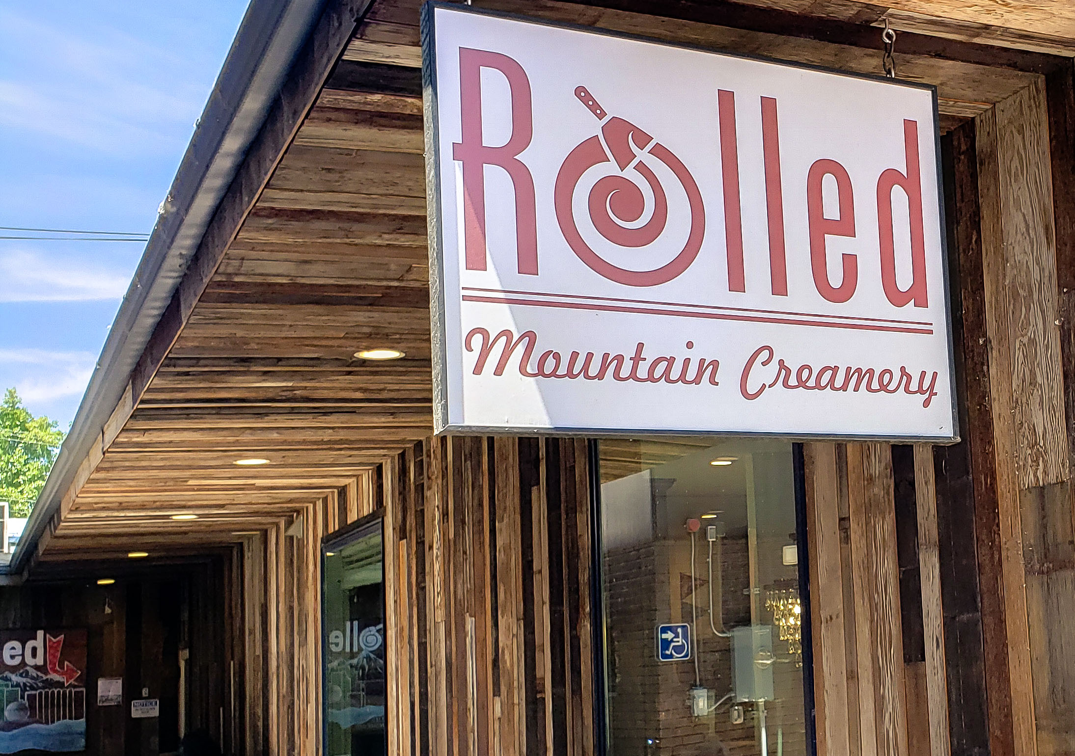 Rolled Mountain Creamery Sign on wood building